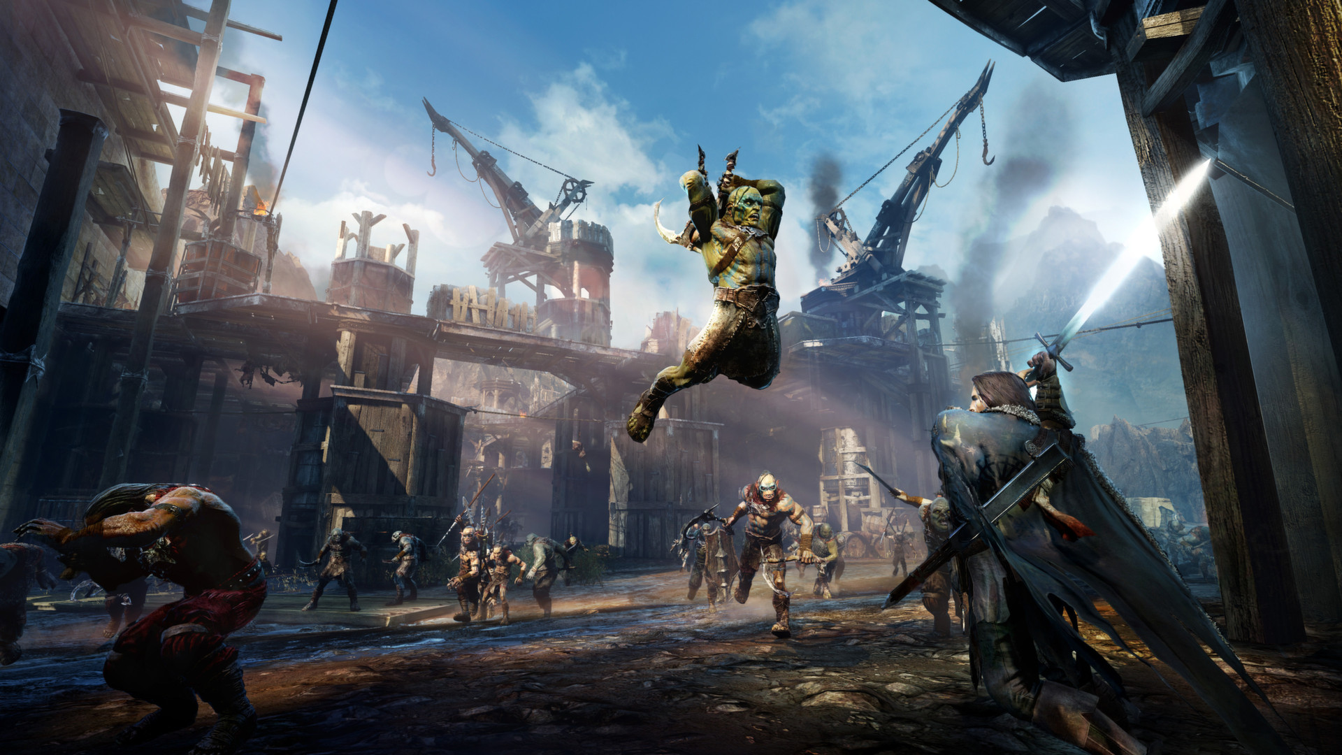 Captura de pantalla del videojuego La Tierra Media: Sombras de Mordor. En la imagen aparecen unas construcciones derruidas y un personaje está saltando en el aire con un objeto en la mano para atacar a otro personaje. En la imagen también se observan a otros NPCs